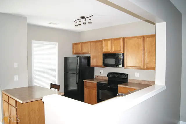 a kitchen with a refrigerator and a sink