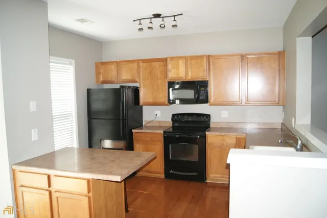 a kitchen with a refrigerator sink and stove