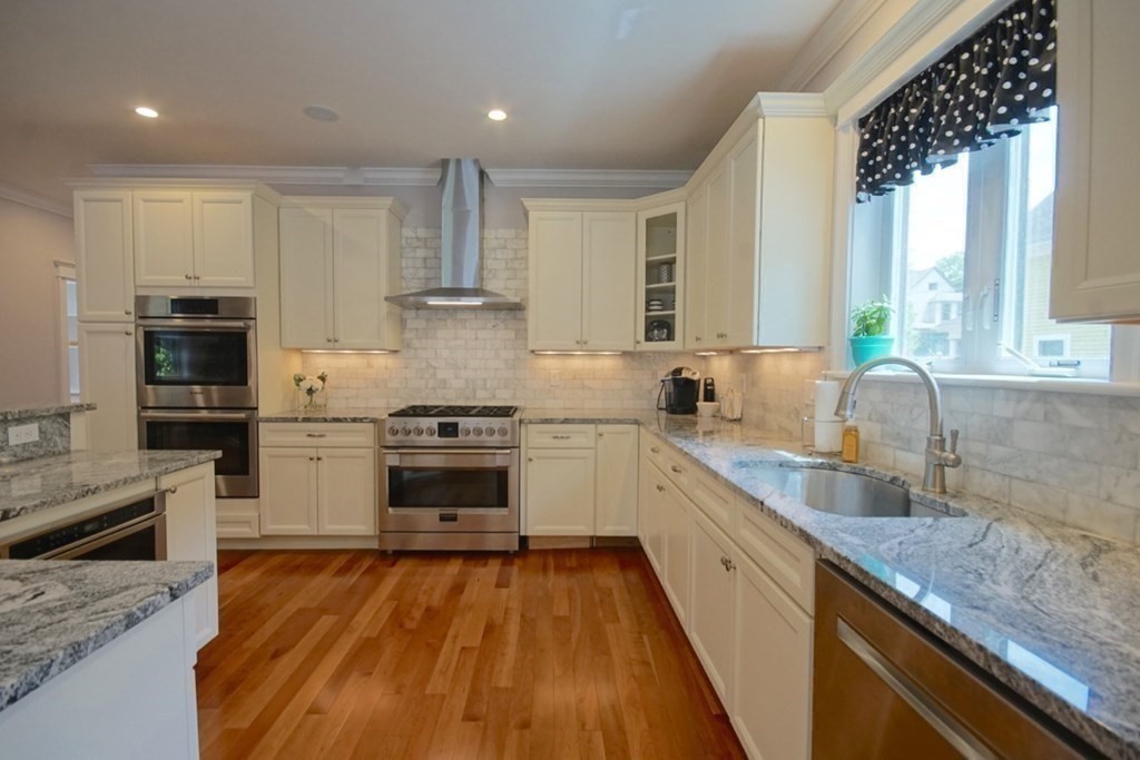 13 Warren Street Needham, MA 02492 - Photo 11 of 34 a kitchen with a stove a sink and a refrigerator