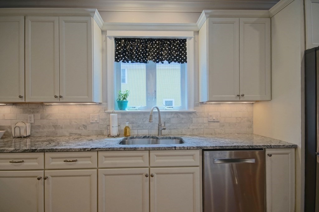 13 Warren Street Needham, MA 02492 - Photo 12 of 34 a kitchen with granite countertop white cabinets and a sink