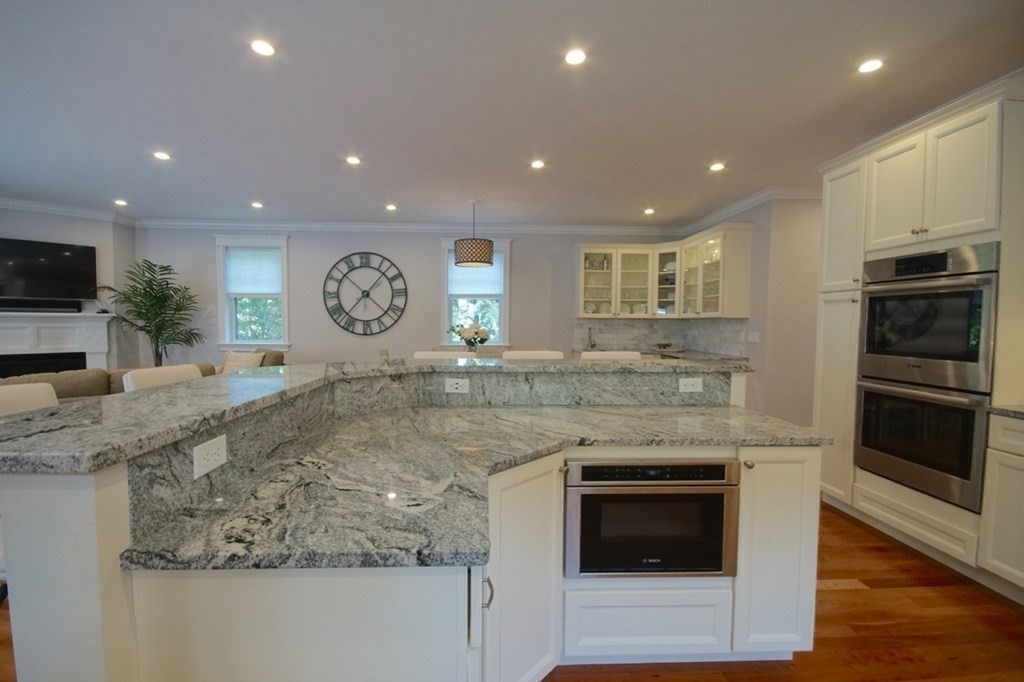 13 Warren Street Needham, MA 02492 - Photo 13 of 34 a kitchen with stainless steel appliances granite countertop a stove a sink and a microwave