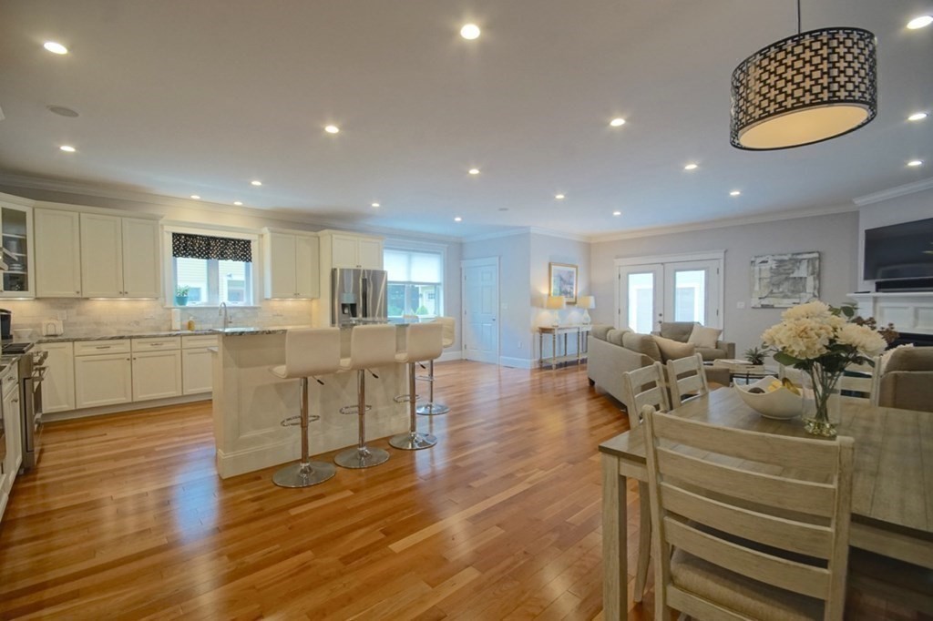 13 Warren Street Needham, MA 02492 - Photo 2 of 34 a living room with furniture and a kitchen view