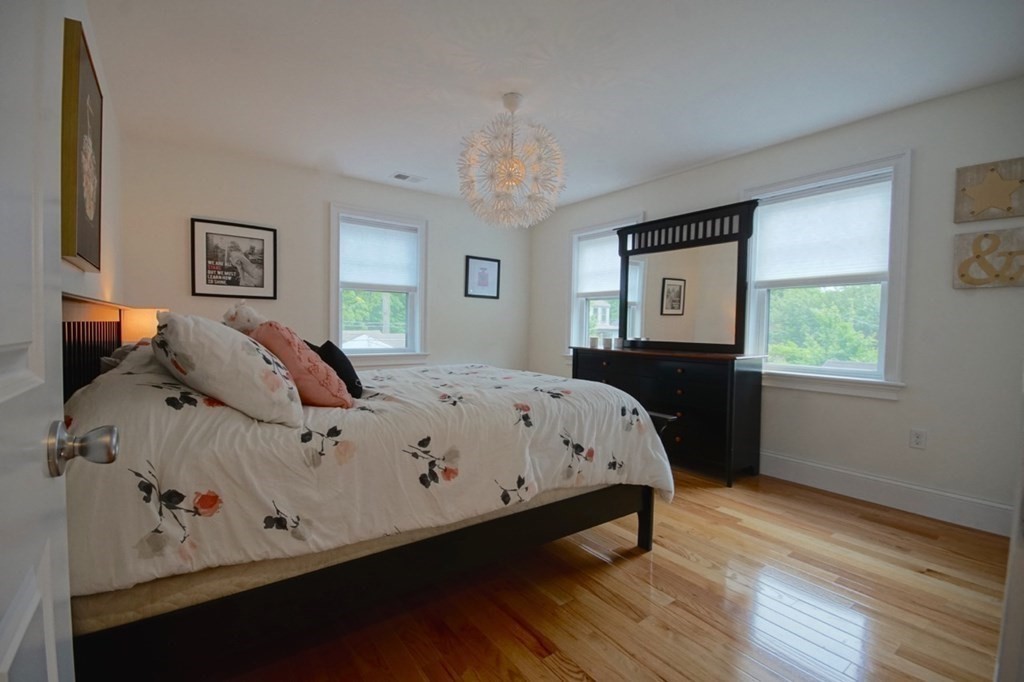 13 Warren Street Needham, MA 02492 - Photo 31 of 34 a large bed sitting in a bedroom next to a window