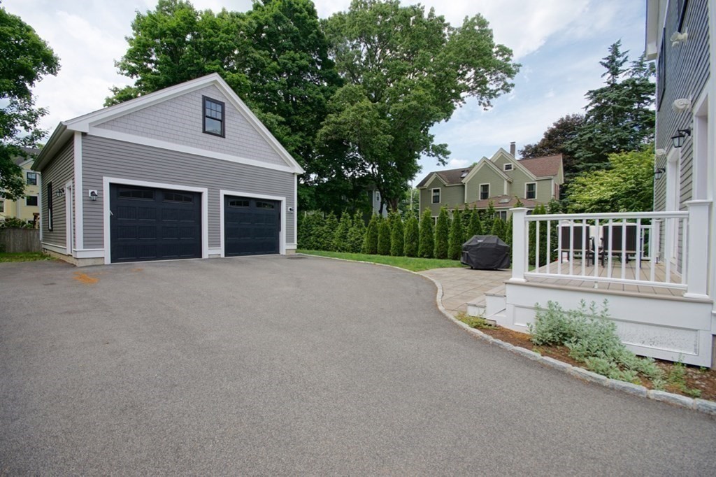 13 Warren Street Needham, MA 02492 - Photo 34 of 34 a front view of a house with a yard and garage