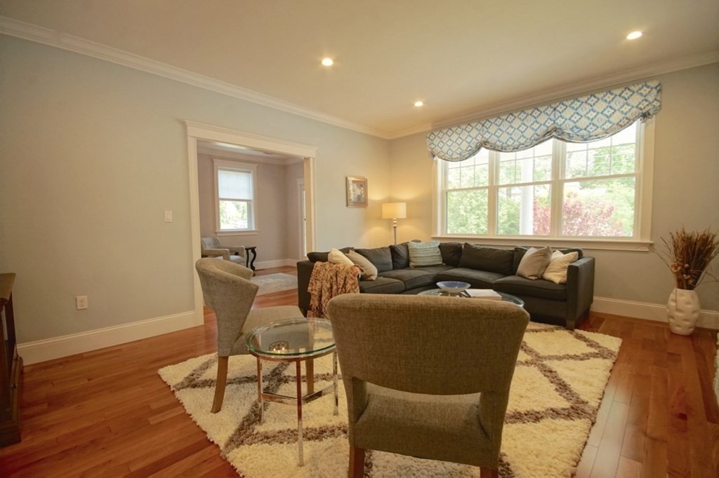 13 Warren Street Needham, MA 02492 - Photo 6 of 34 a living room with furniture a large window and wooden floor