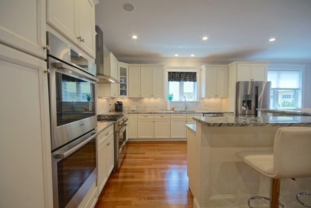 13 Warren Street Needham, MA 02492 - Photo 10 of 34 a kitchen with stainless steel appliances granite countertop a stove a sink and a refrigerator