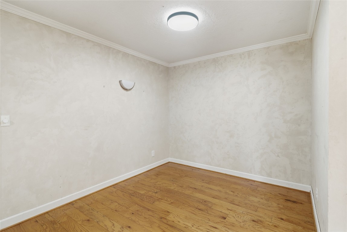 2003 Richvale Lane Houston, TX 77062 - Photo 11 of 29 a view of an empty room with wooden floor and a window