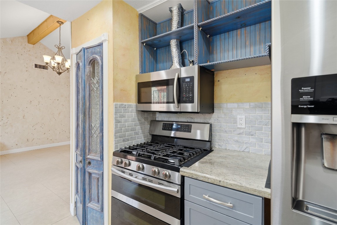 2003 Richvale Lane Houston, TX 77062 - Photo 14 of 29 a kitchen with stainless steel appliances granite countertop a stove and a refrigerator