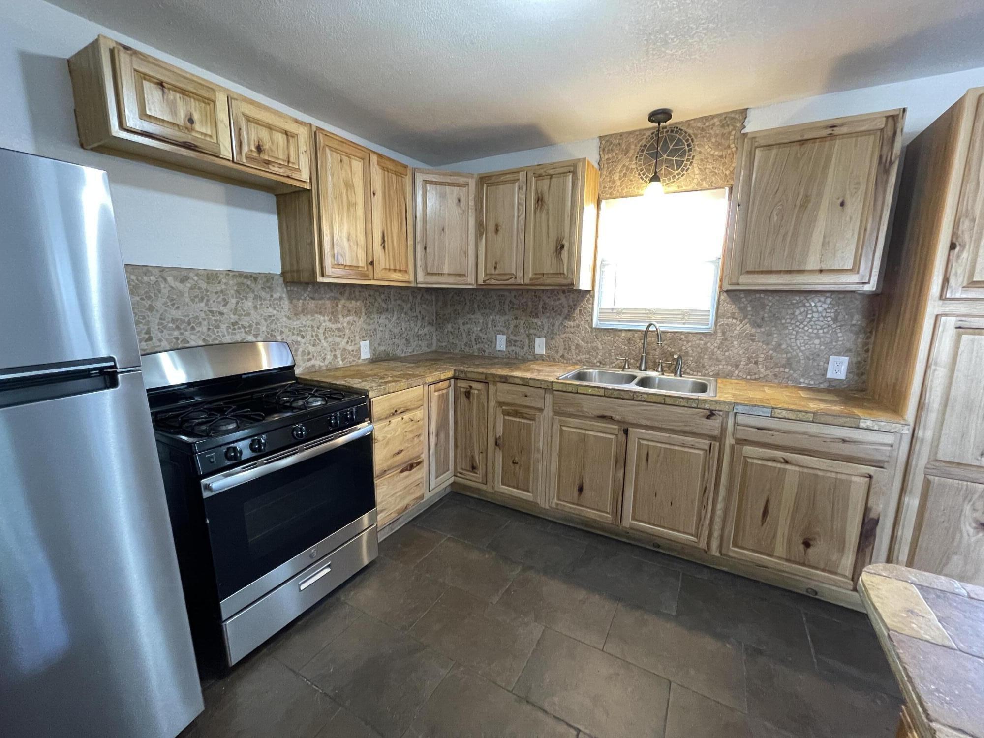 4813 37th Street Lubbock, TX 79414 - Photo 3 of 12 a kitchen with a sink stove and cabinets