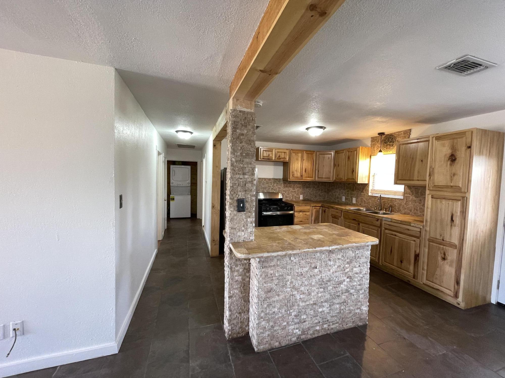 4813 37th Street Lubbock, TX 79414 - Photo 6 of 12 a large kitchen with lots of counter space cabinetry and stainless steel appliances