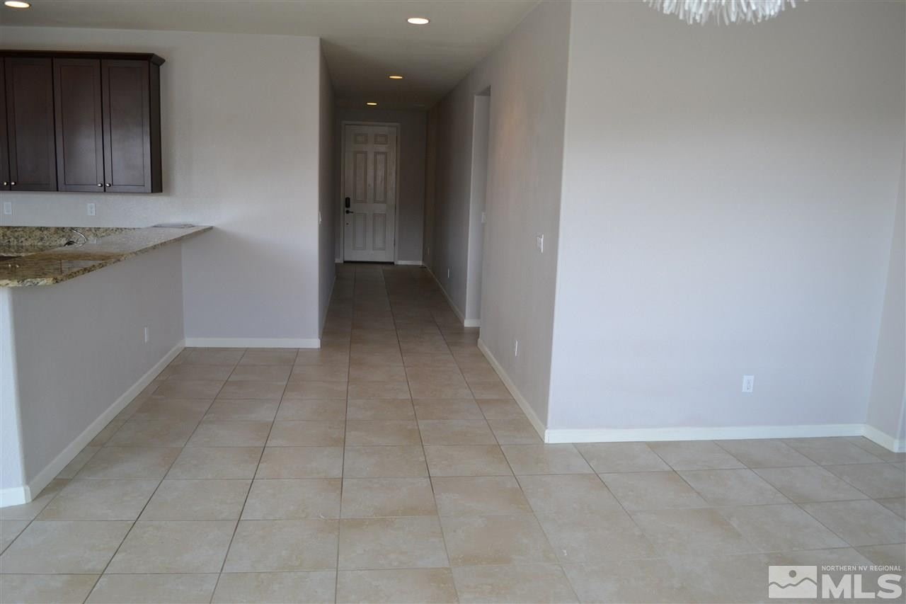 10790 Ridgebrook Drive Reno, NV 89521 - Photo 3 of 16 a view of kitchen with granite countertop cabinets and entryway