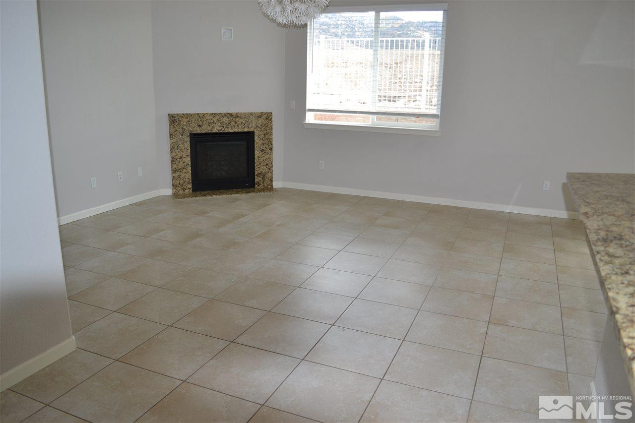 10790 Ridgebrook Drive Reno, NV 89521 - Photo 8 of 16 an empty room with windows and fireplace