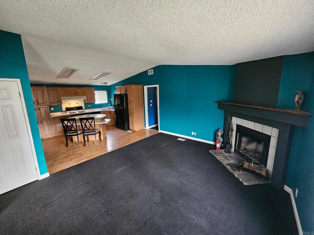 26455 Paradise Valley Road, Unit 62 Warner Springs, CA 92086 - Photo 9 of 19 a dining room with furniture and a fireplace