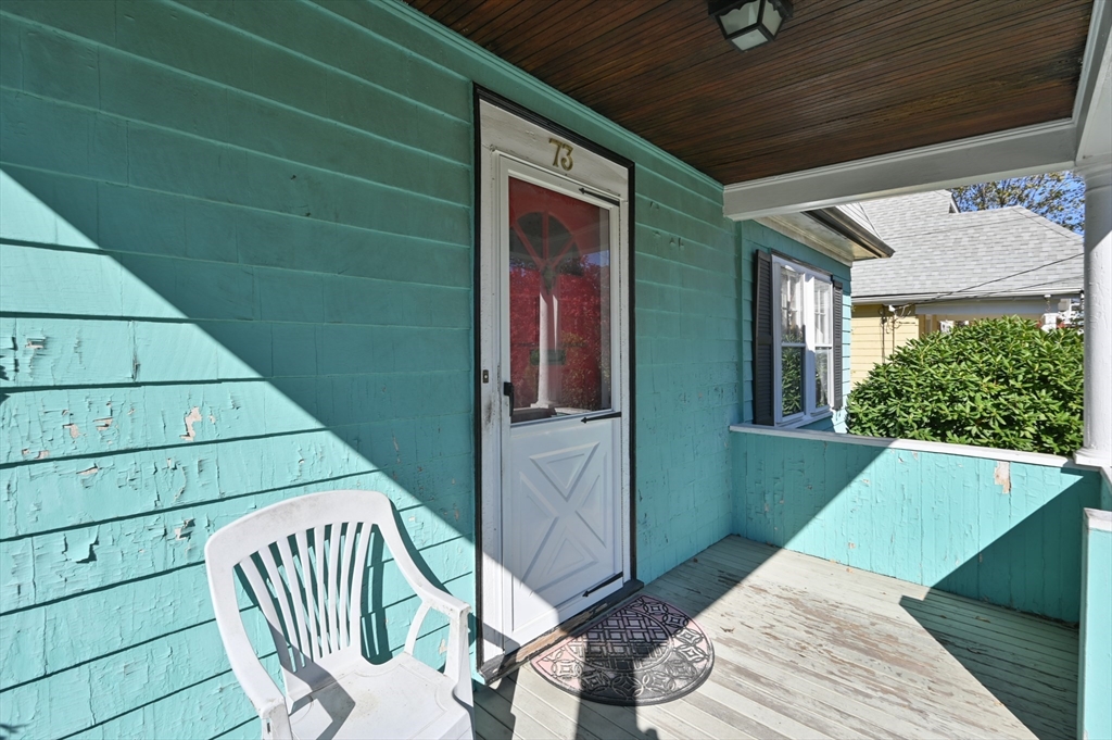 73 Woodard Road Boston, MA 02132 - Photo 13 of 20 a balcony with table and chairs