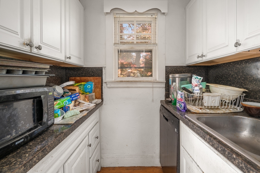 73 Woodard Road Boston, MA 02132 - Photo 5 of 20 a kitchen with stainless steel appliances a sink a stove and cabinets