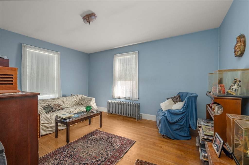 73 Woodard Road Boston, MA 02132 - Photo 7 of 20 a living room with furniture and a window