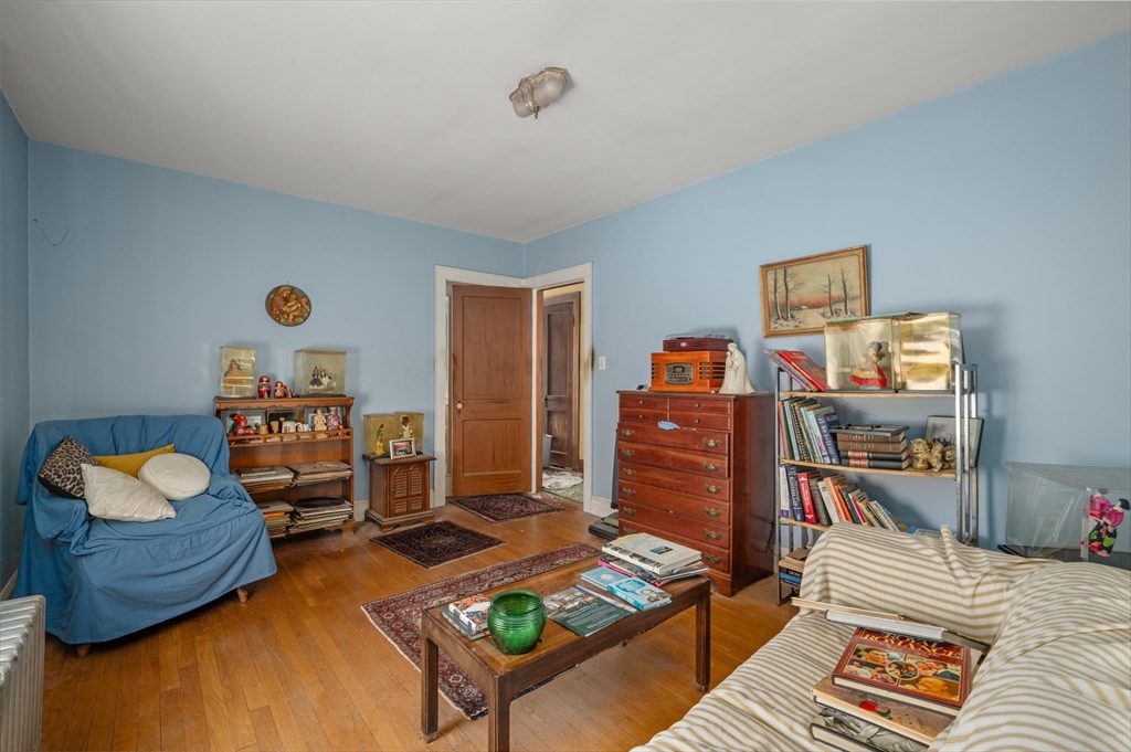 73 Woodard Road Boston, MA 02132 - Photo 8 of 20 a bedroom with a bed and a couch