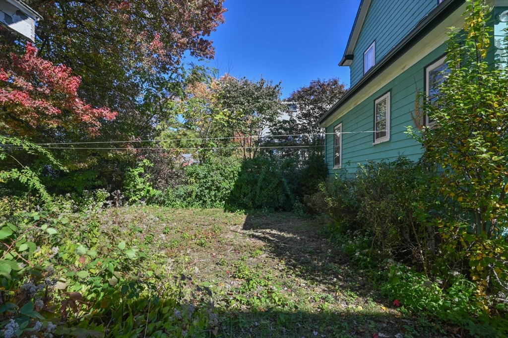 73 Woodard Road Boston, MA 02132 - Photo 10 of 20 a backyard of a house with lots of green space