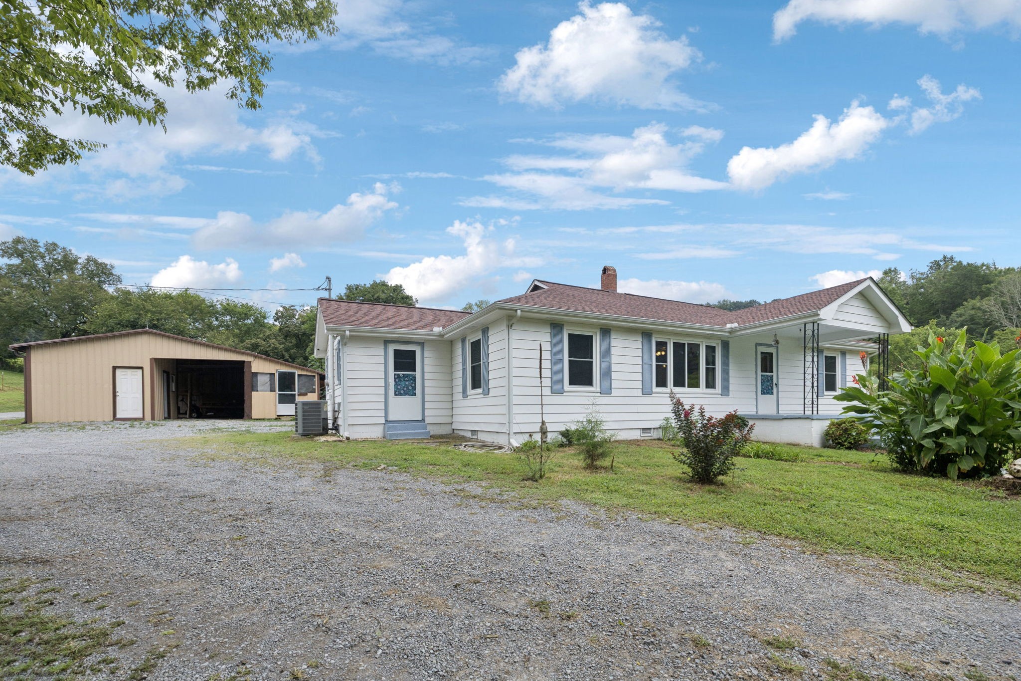 994 Bull Run Road Lynchburg, TN 37352 - Photo 10 of 76 a front view of a house with a garden and trees