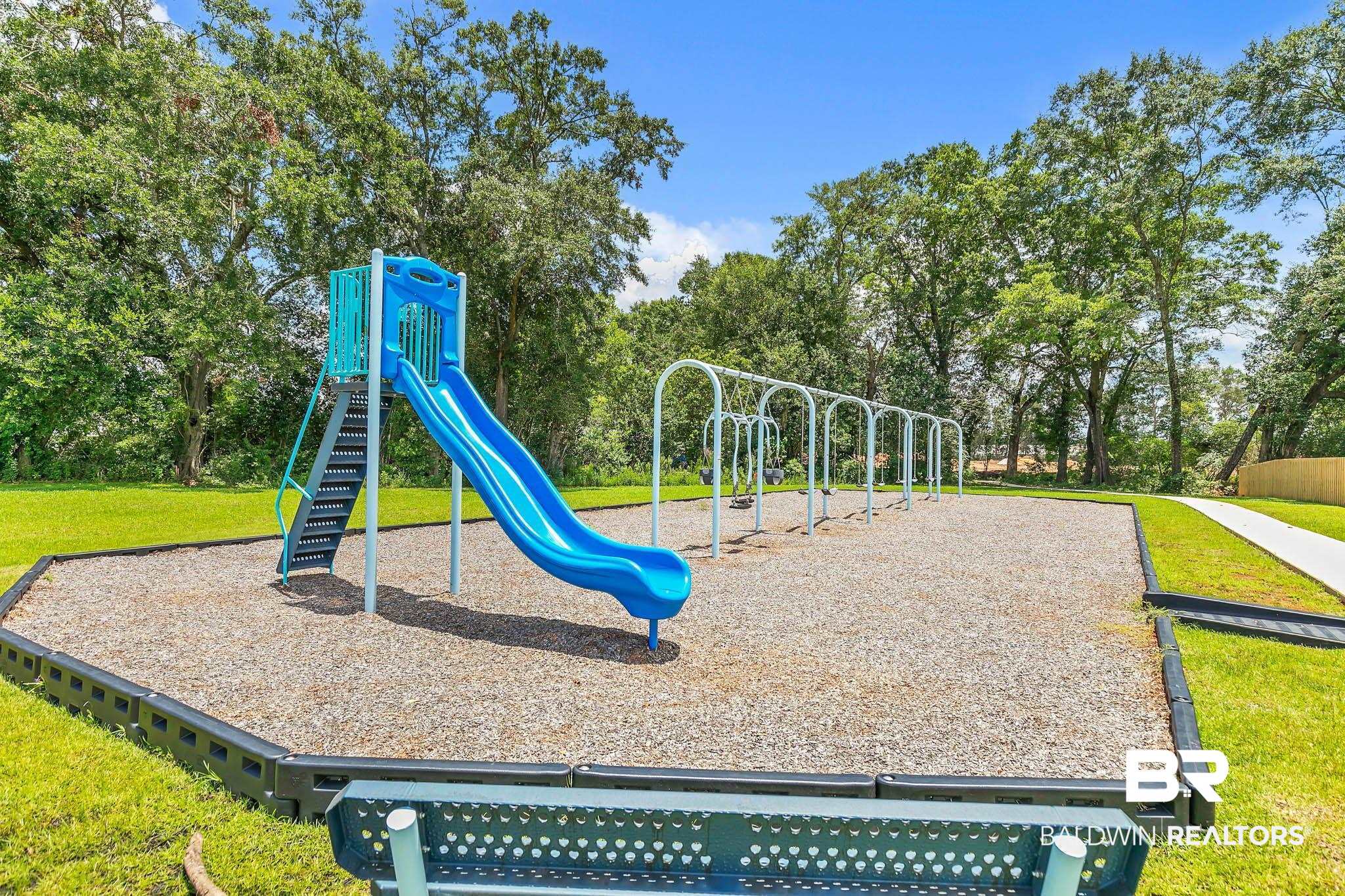 17217 REFLECTION Street Loxley, AL 36551 - Photo 48 of 83 Community playground with a yard and view of wooded area