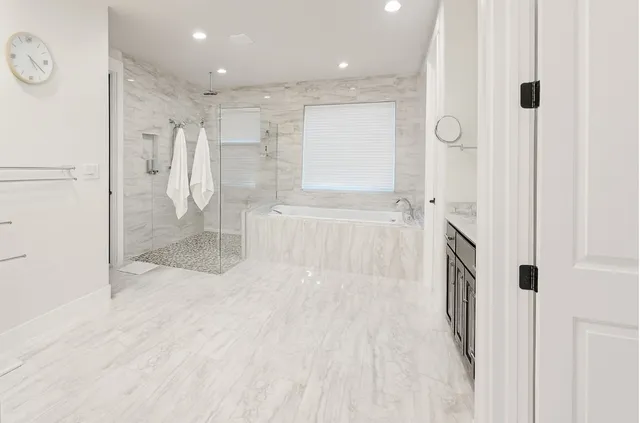 a bathroom with a bathtub and a shower
