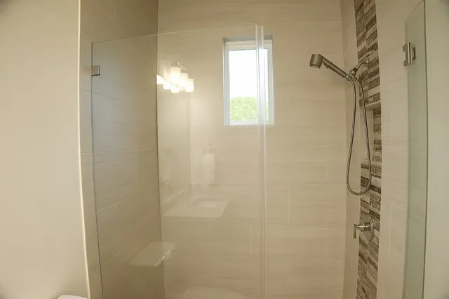 a white toilet sitting next to a bathroom sink