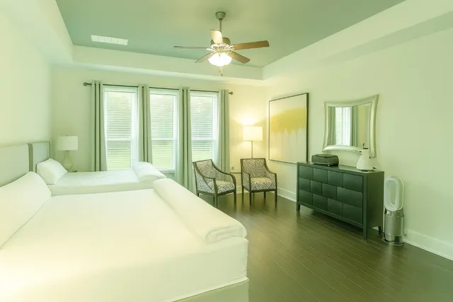 a spacious bedroom with a bed and a chandelier