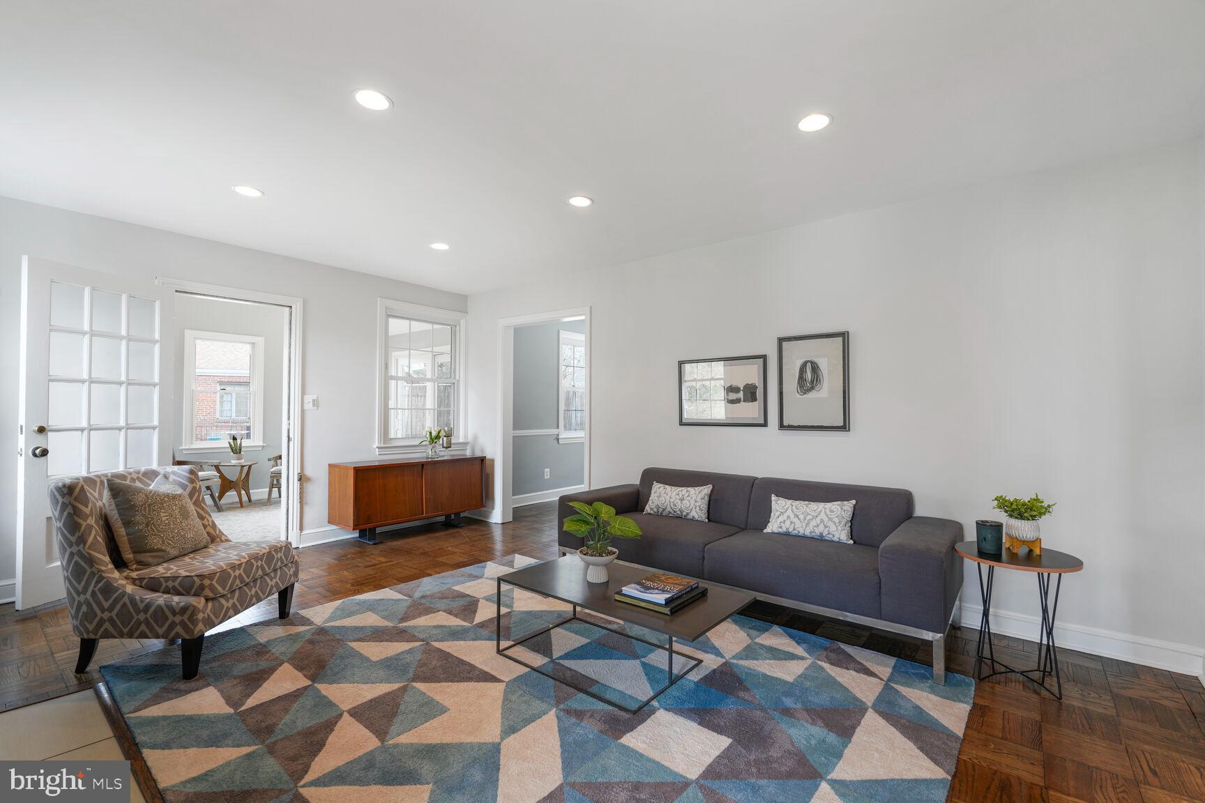 9213 Bradford Road Silver Spring, MD 20901 - Photo 11 of 34 a living room with furniture a rug and a flat screen tv