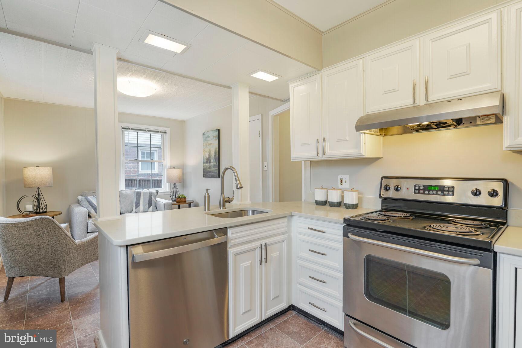 9213 Bradford Road Silver Spring, MD 20901 - Photo 15 of 34 a kitchen with a sink stove and cabinets