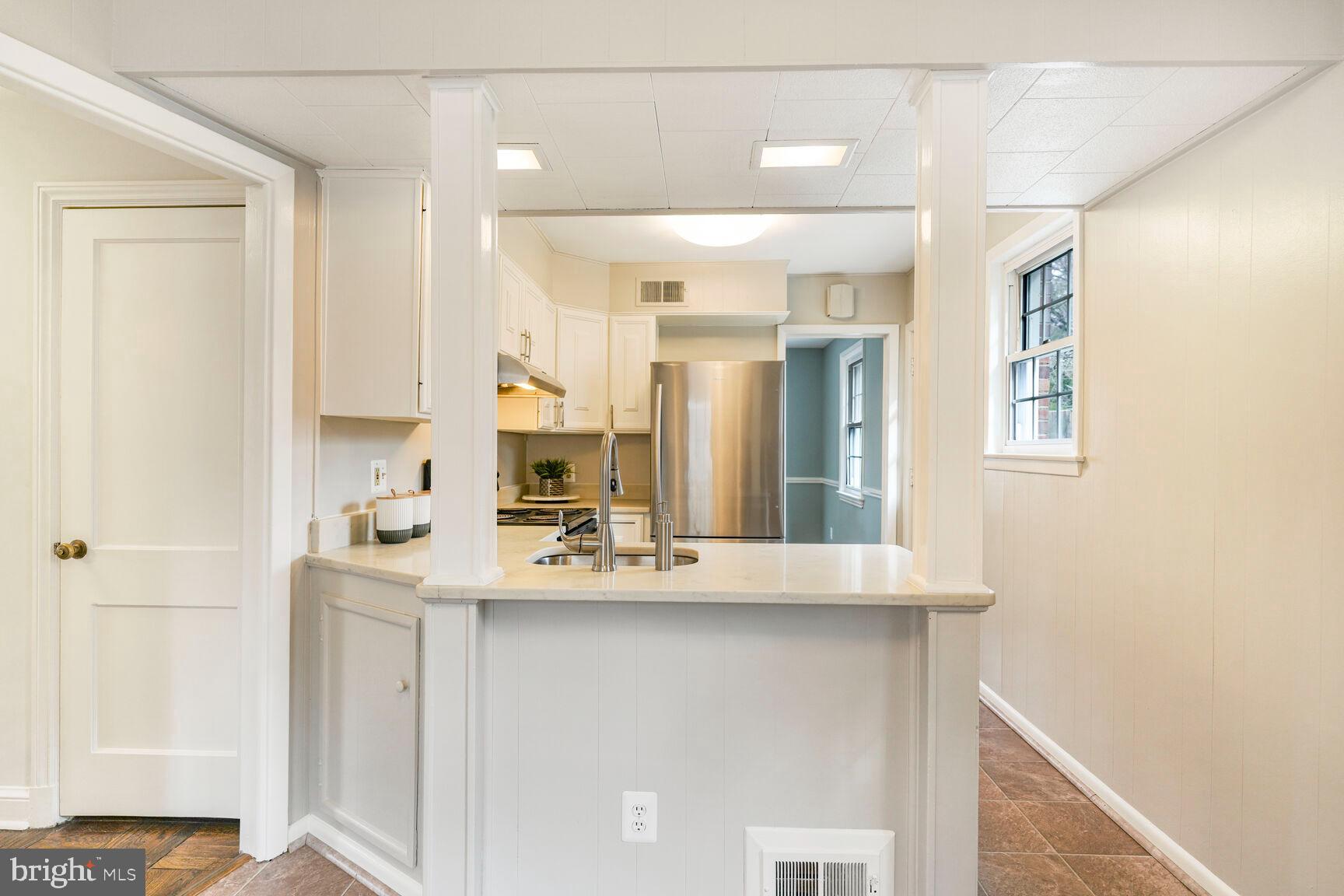 9213 Bradford Road Silver Spring, MD 20901 - Photo 21 of 34 a bathroom with a sink a mirror and a shower