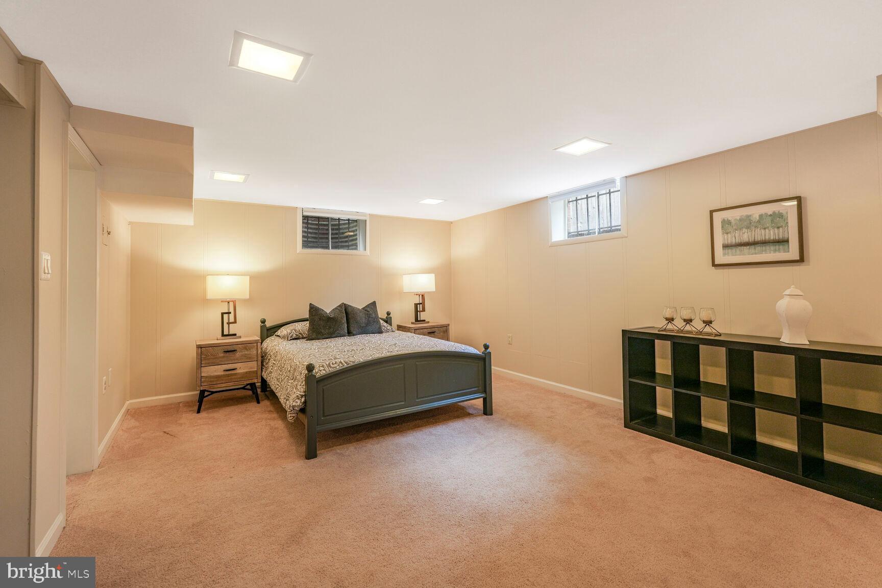 9213 Bradford Road Silver Spring, MD 20901 - Photo 27 of 34 a spacious bedroom with a bed and a window