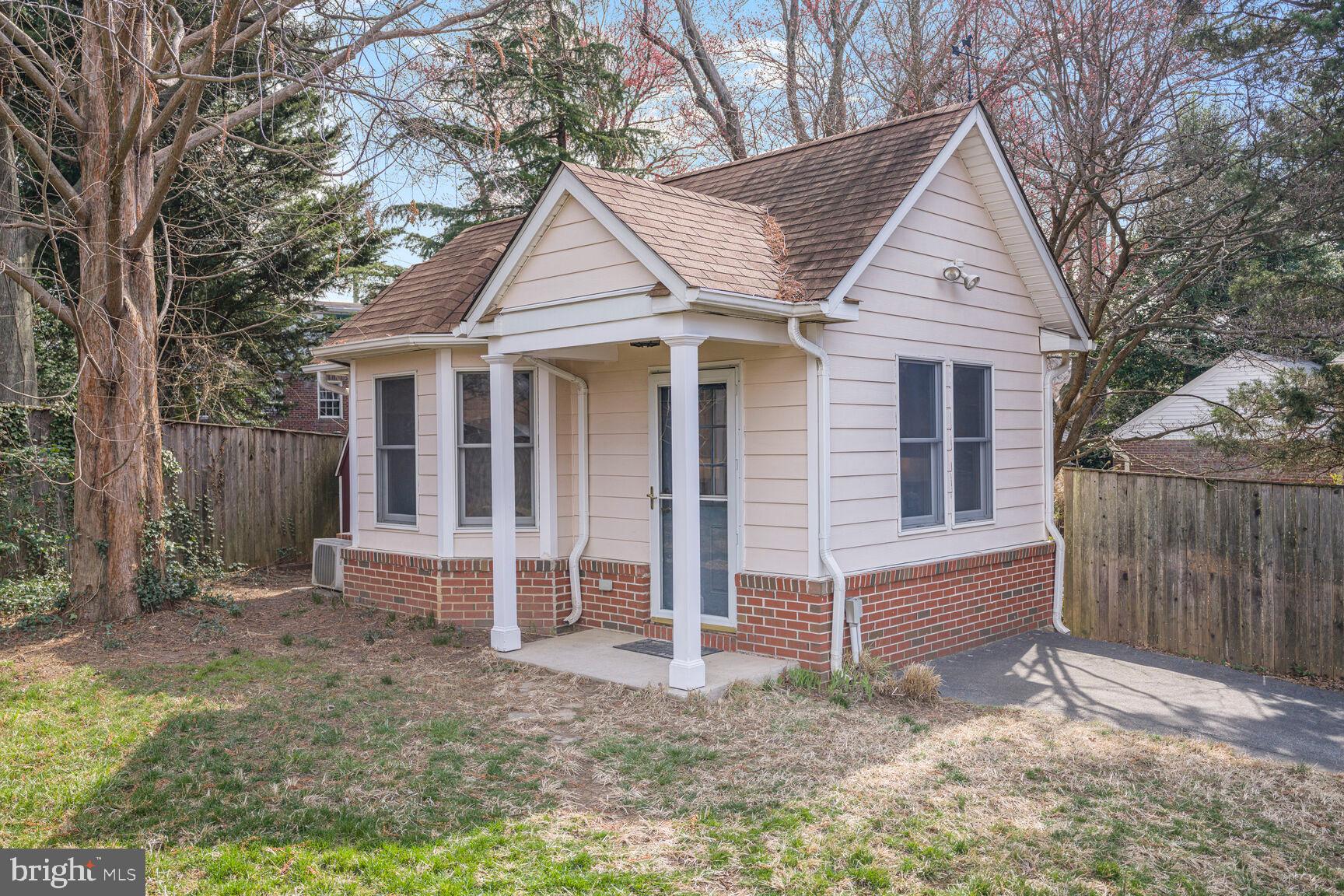 9213 Bradford Road Silver Spring, MD 20901 - Photo 3 of 34 a view of white house with a yard and large tree