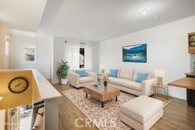 624 Corte Patio, Unit 81 Chula Vista, CA 91914 - Photo 14 of 35 a living room with furniture a clock on wall and a table