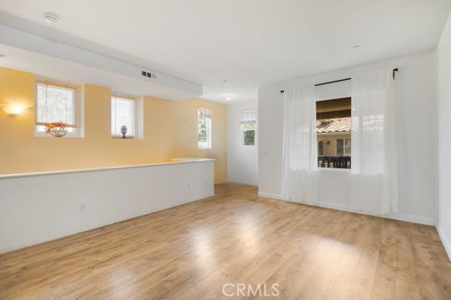 624 Corte Patio, Unit 81 Chula Vista, CA 91914 - Photo 20 of 35 a view of an empty room with wooden floor and a window