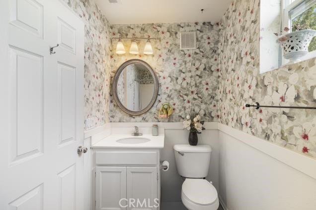 624 Corte Patio, Unit 81 Chula Vista, CA 91914 - Photo 28 of 35 a bathroom with a sink a toilet and a mirror