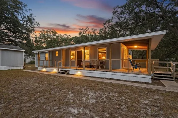 a view of a house with backyard and porch