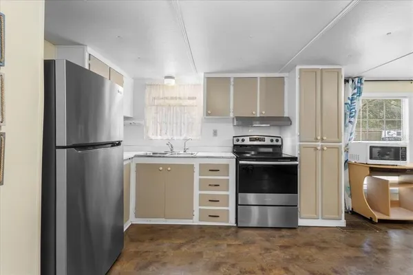 a kitchen with a refrigerator and a stove