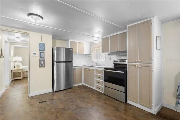 a kitchen with stainless steel appliances a refrigerator a stove a microwave and cabinets