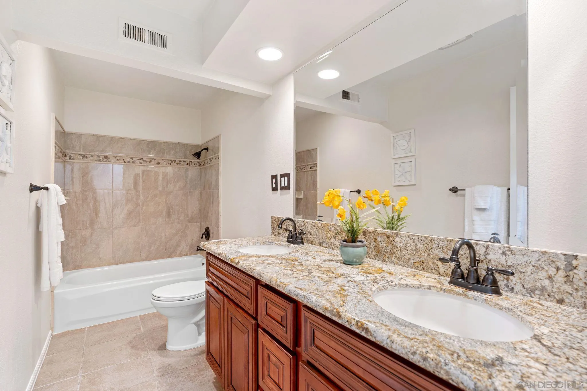 3533 Oakleaf Court Spring Valley, CA 91977 - Photo 19 of 38 a bathroom with a granite countertop double vanity sink toilet mirror and bathtub