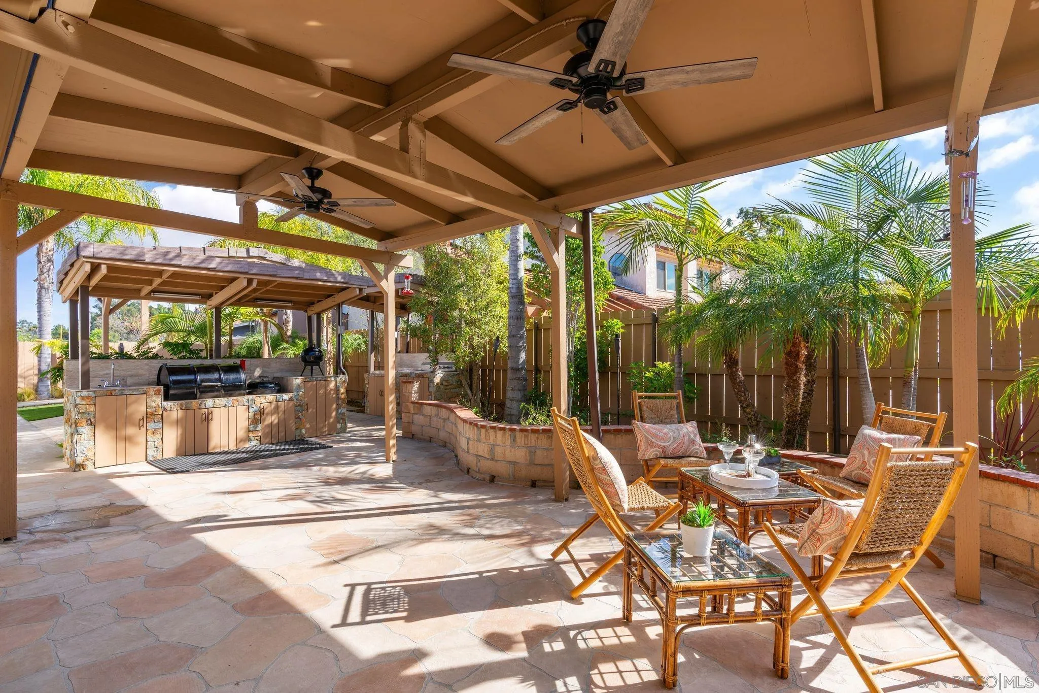 3533 Oakleaf Court Spring Valley, CA 91977 - Photo 22 of 38 a view of a patio with a table and chairs under an umbrella with a small yard