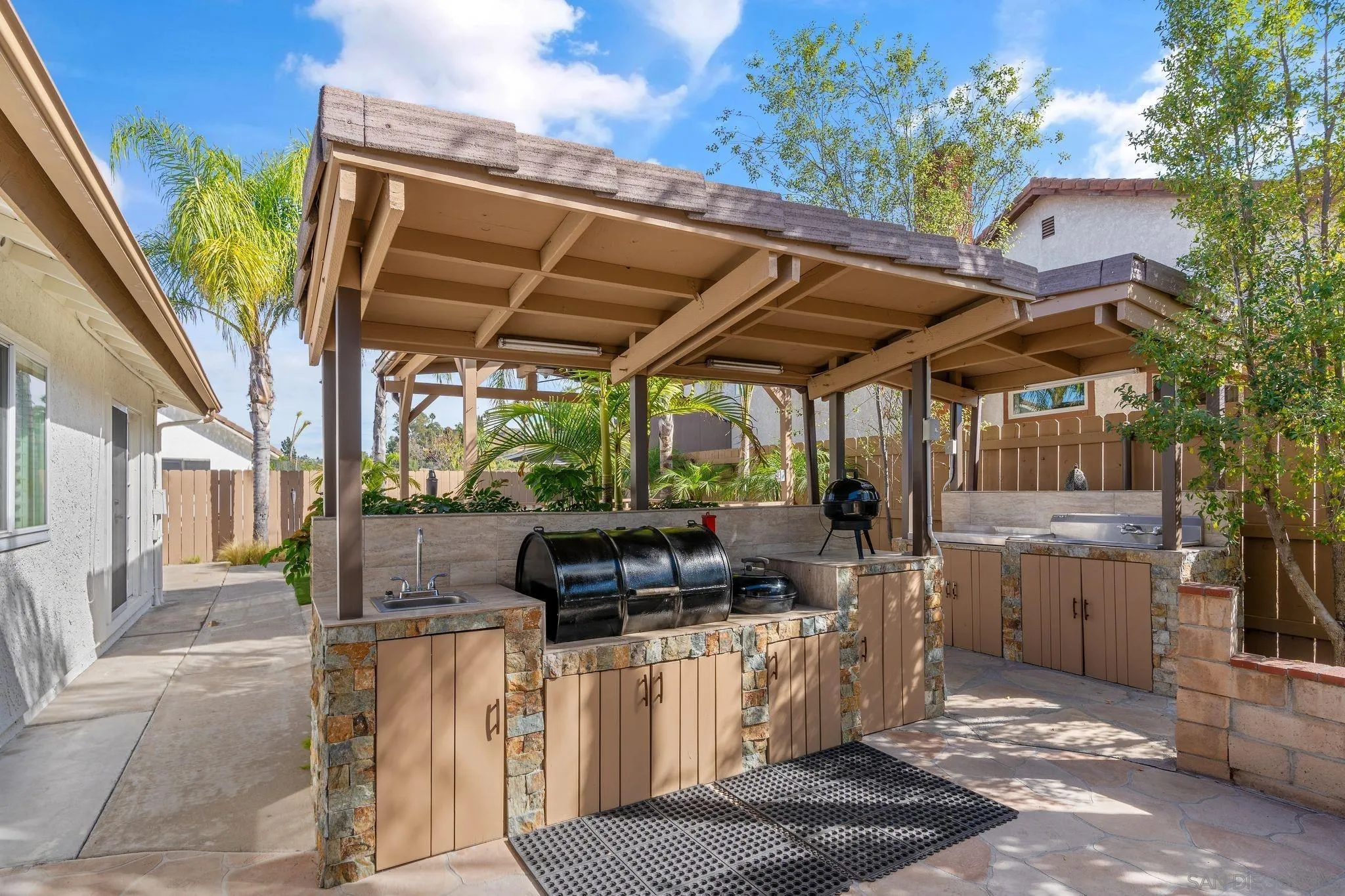 3533 Oakleaf Court Spring Valley, CA 91977 - Photo 24 of 38 a view of a patio with table and chairs with wooden floor and fence