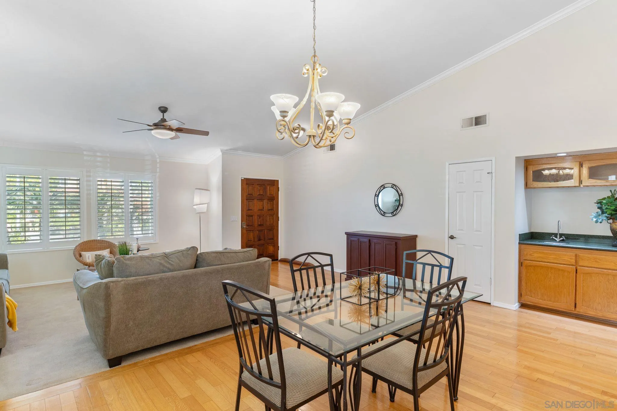 3533 Oakleaf Court Spring Valley, CA 91977 - Photo 5 of 38 a view of a dining room with furniture a chandelier and wooden floor