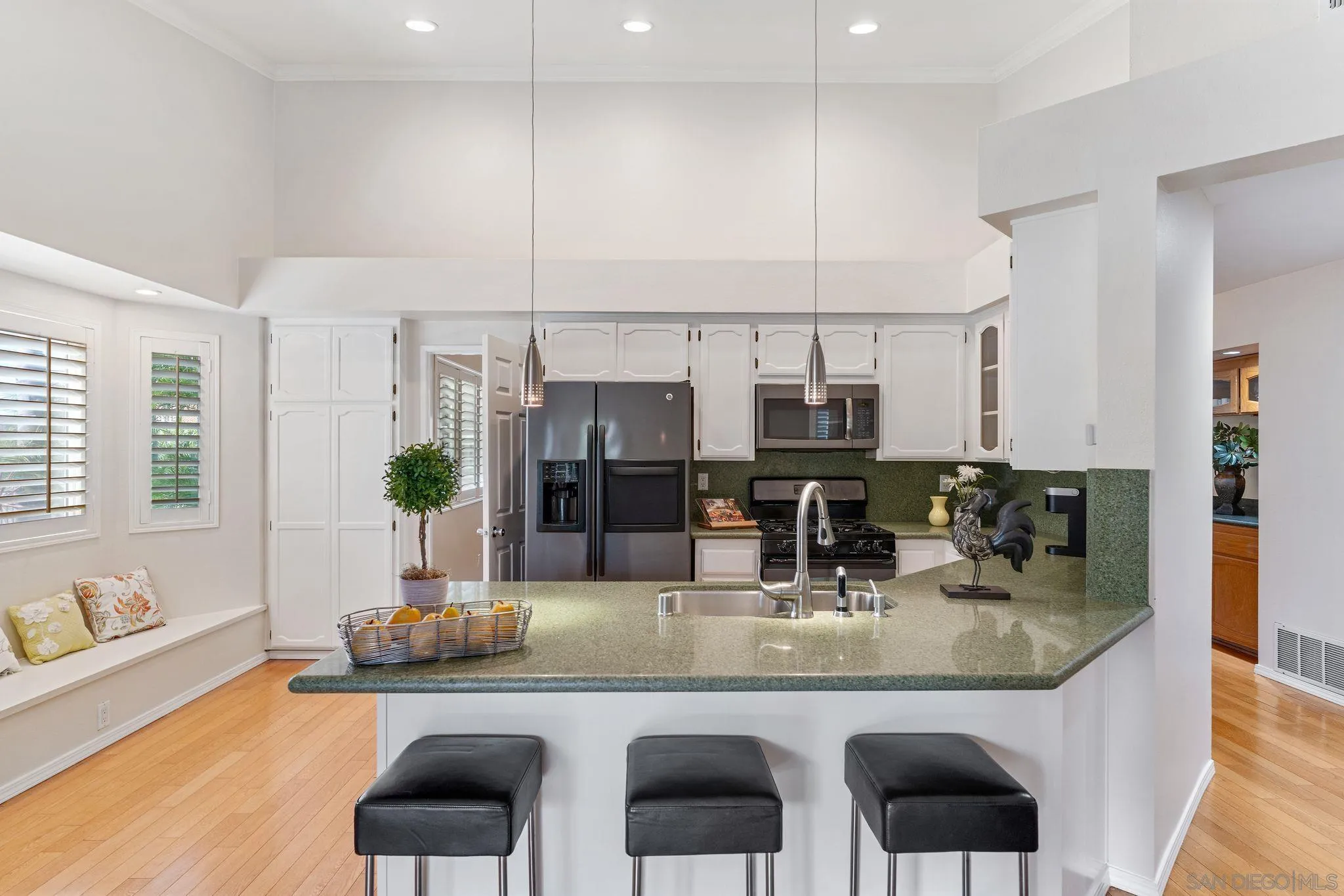 3533 Oakleaf Court Spring Valley, CA 91977 - Photo 9 of 38 a kitchen with granite countertop a sink and white cabinets