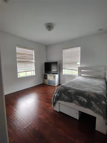 a spacious bedroom with a bed and a window