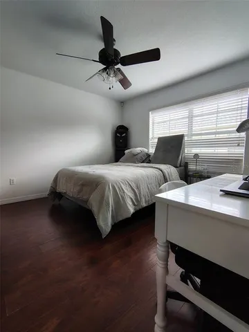 a bedroom with bed and a ceiling fan