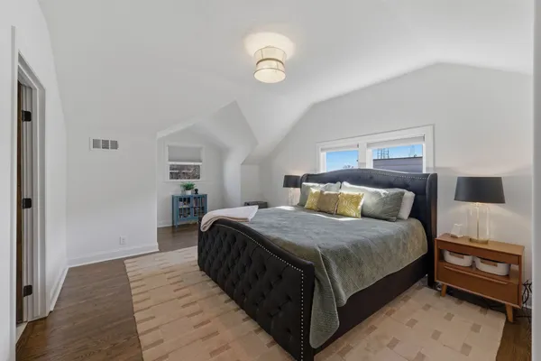 a bedroom with bed and a chandelier