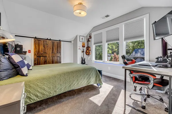 a bed room with a bed and a window