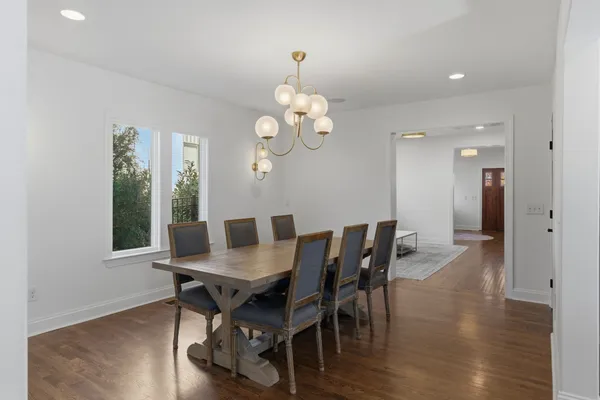 a view of a dining room with furniture and wooden floor