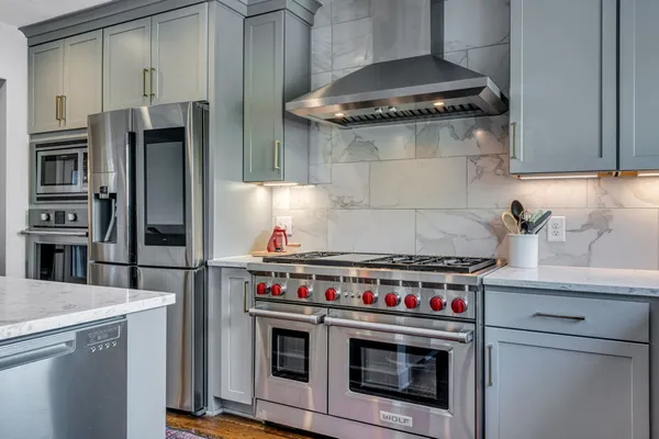 a stove top oven sitting inside of a kitchen