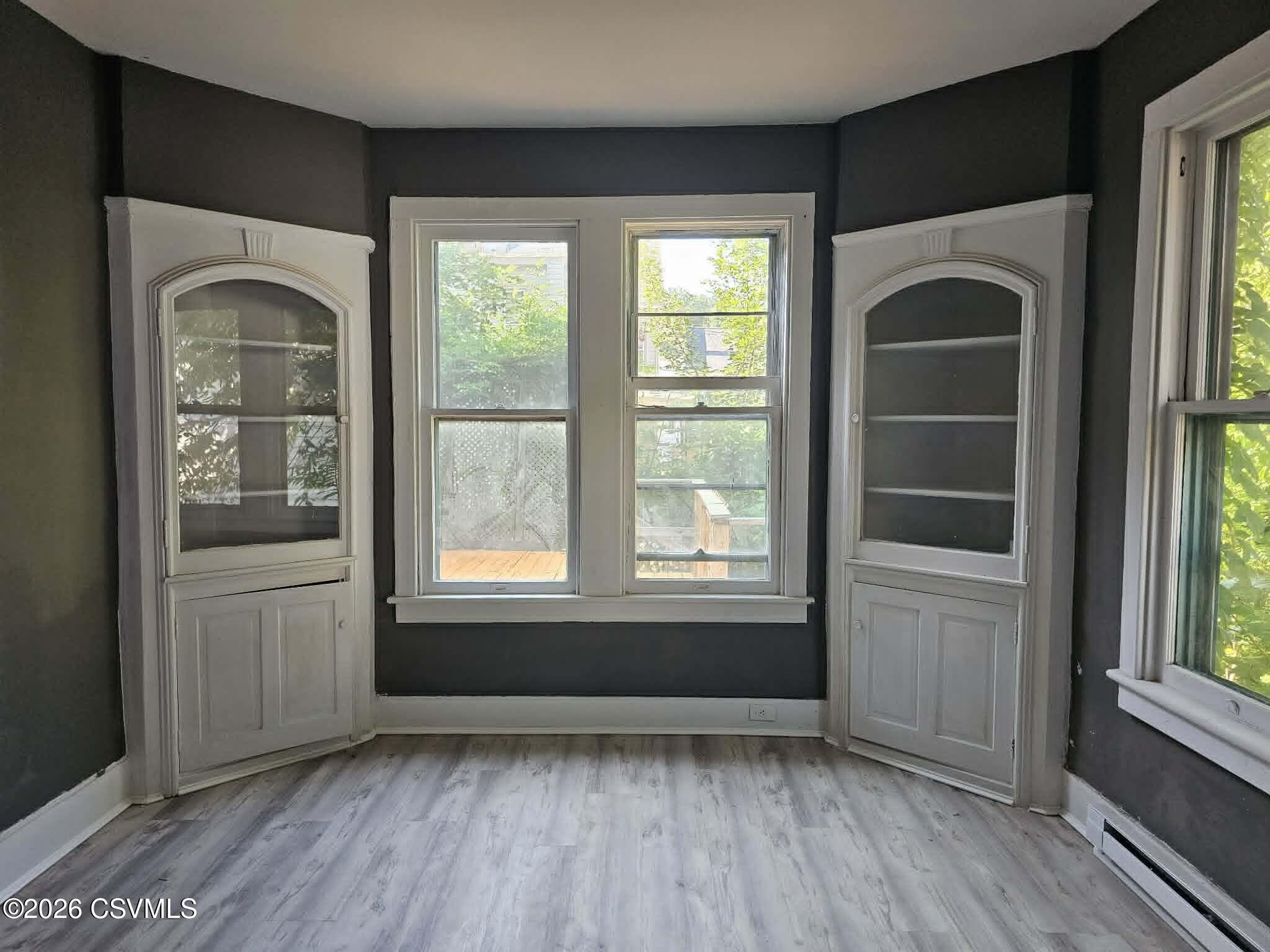 110 Birch Street Shamokin, PA 17872 - Photo 8 of 19 a view of an empty room with a window and wooden floor